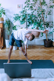 Young boy doing exercises at home.
