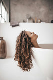 Woman relaxing in bathtub