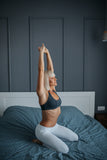 Woman stretching in bed.