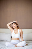 Woman sitting in bed.