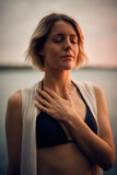 Exercise for when jaw clicks featuring woman with hand on chest.