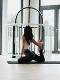 Woman doing somatic exercises on a mat.