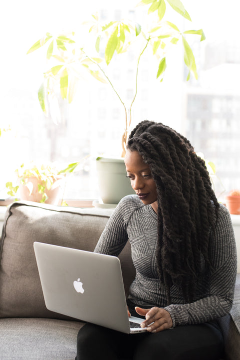 Woman working on laptop.