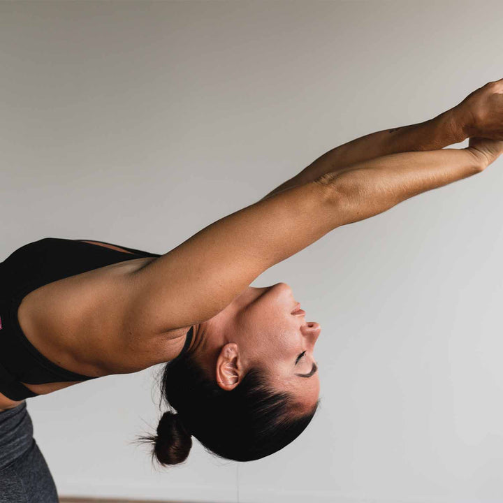 Woman performing somatic exercise for shoulders.