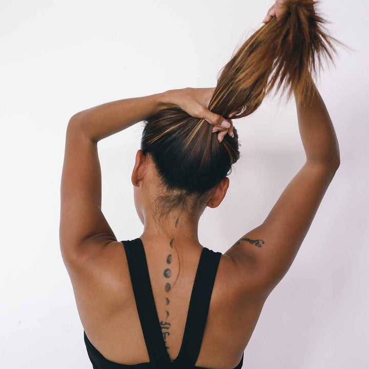 How to relieve shoulder pain with woman holding up hair. 